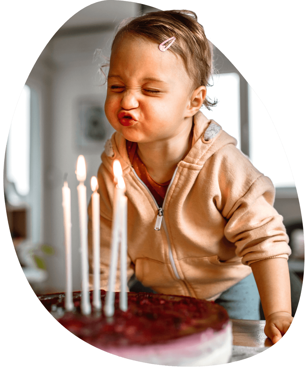 Girl blowing out candles on birthday cake
